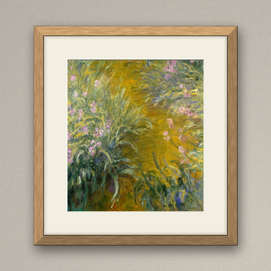 Monet’s The Path through the Irises in a natural oak frame with a wide ivory mount, on a warm grey wall