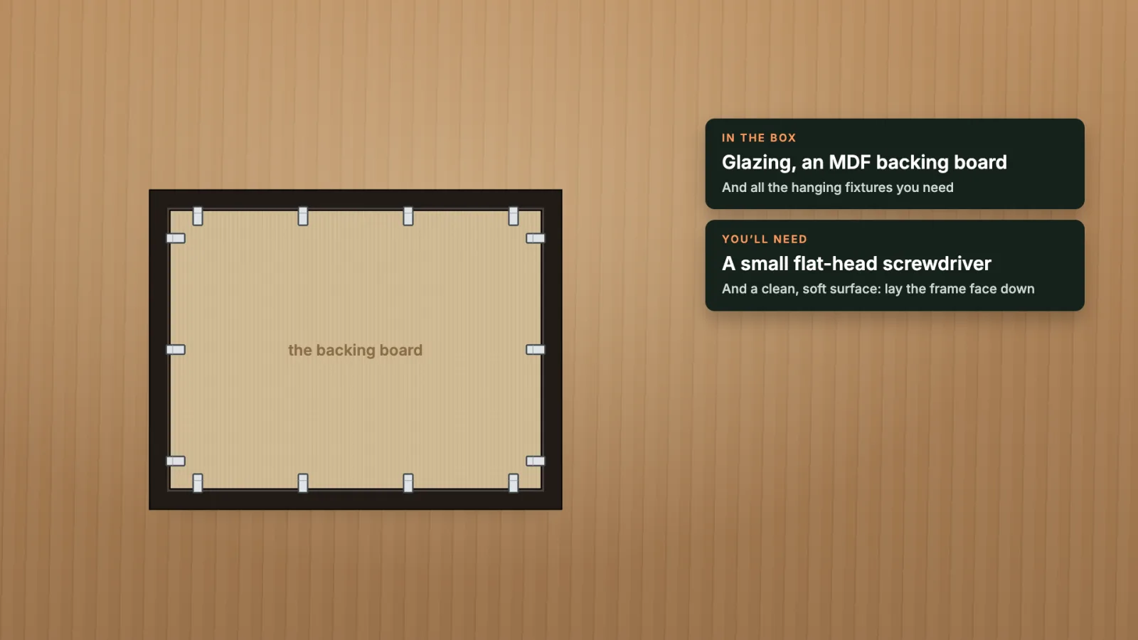 The back of the wood frame, face down, with its backing board and flexible tabs.